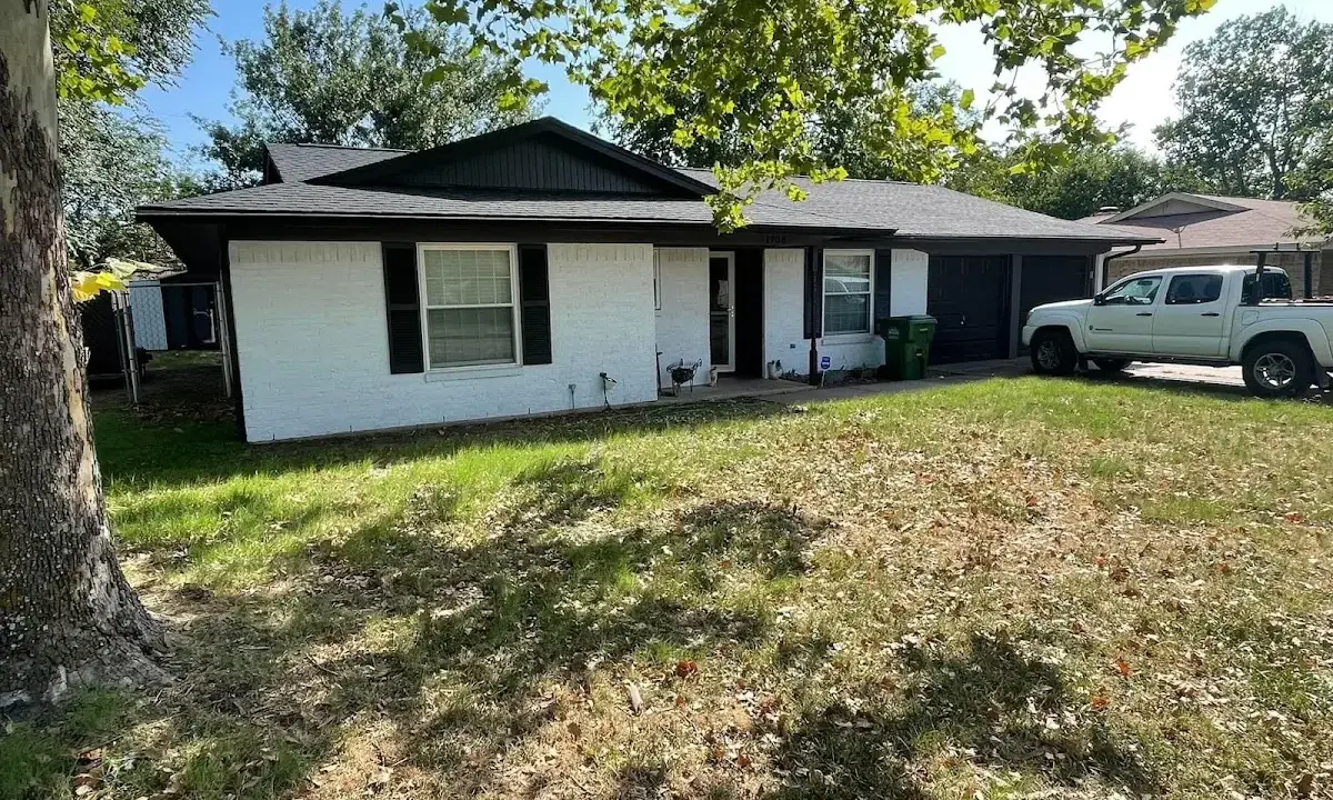 Professional roofing crew working on a residential roof in Elkins